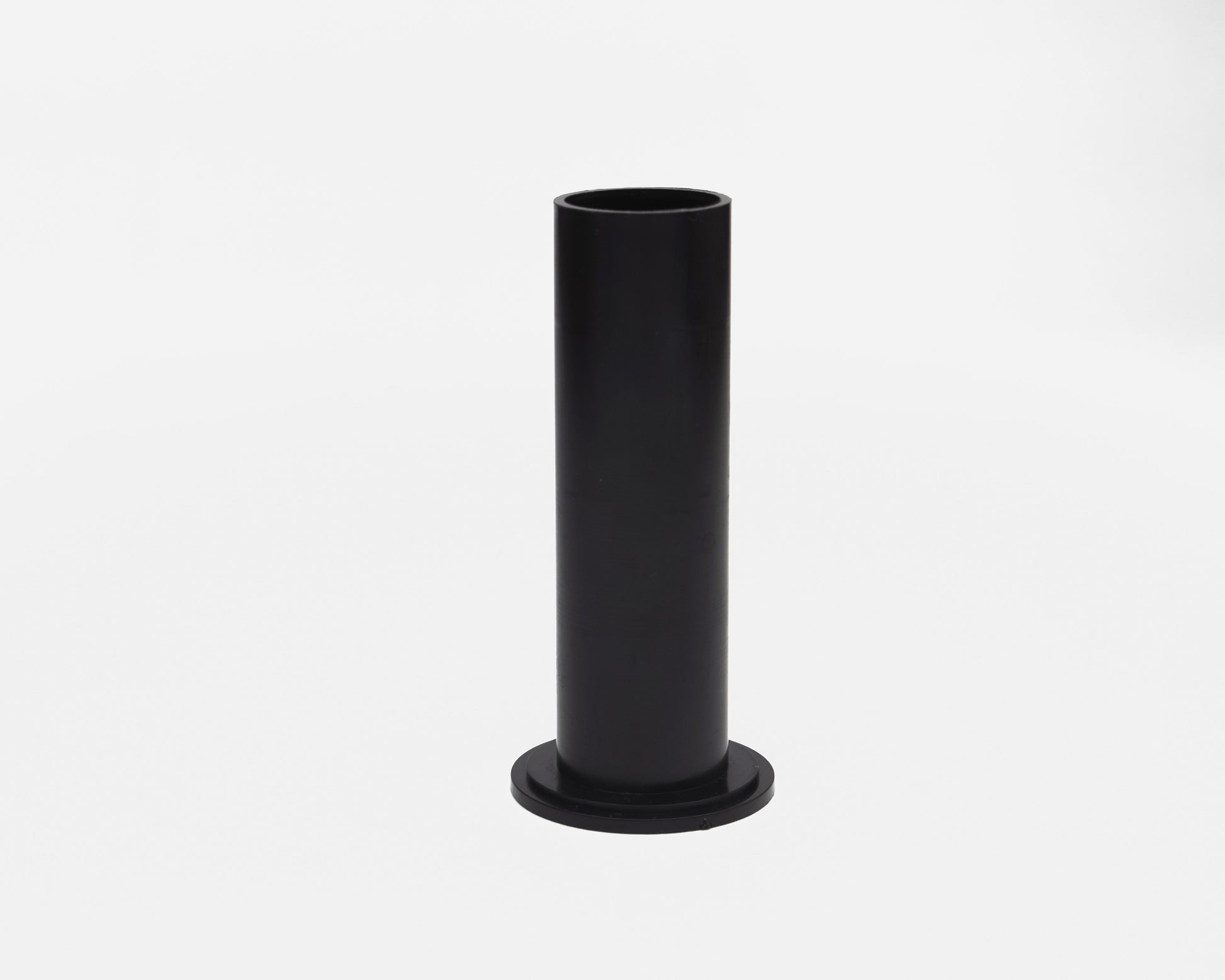 Black cylindrical object on a white background