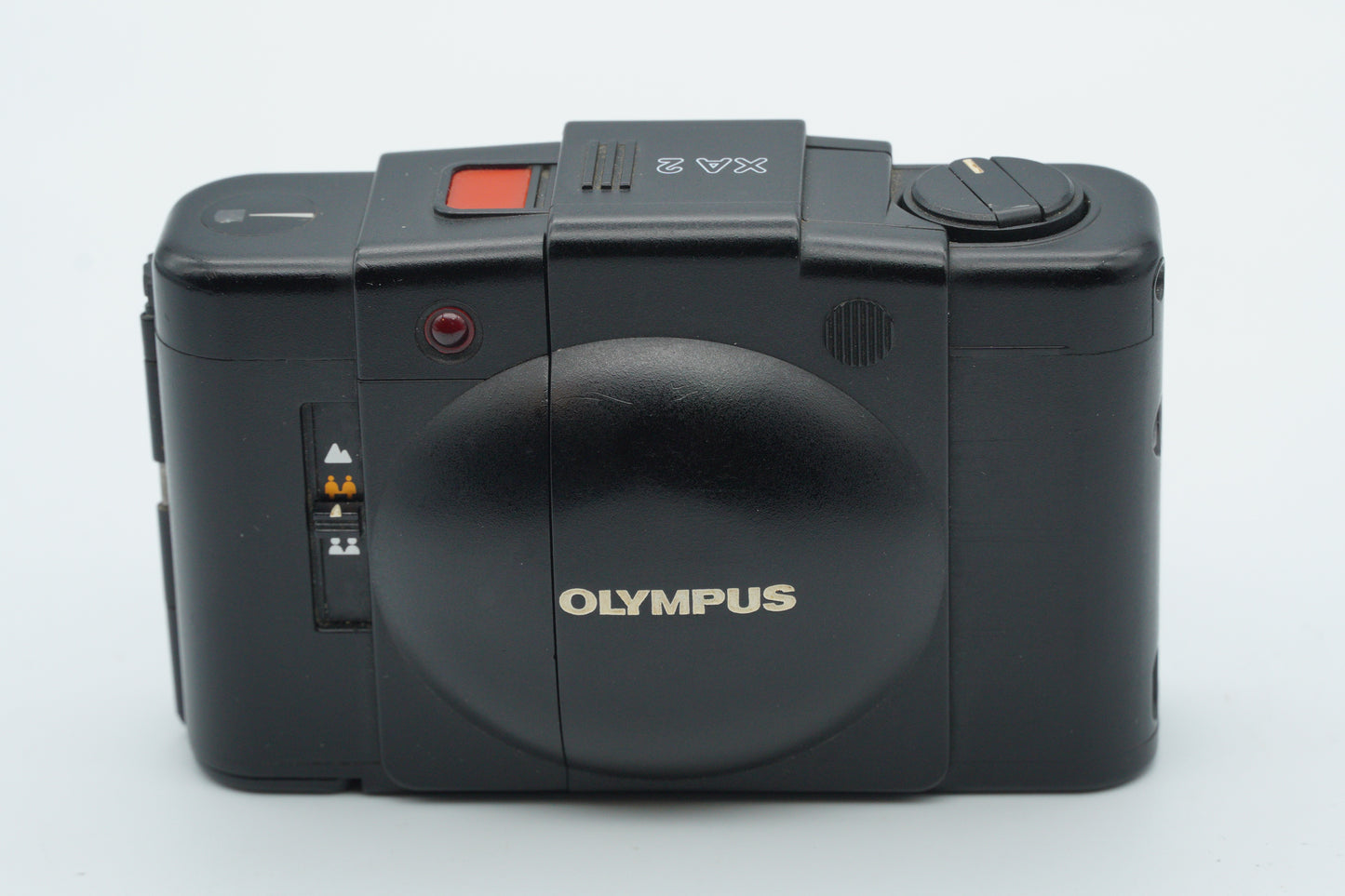Black Olympus camera on a white background