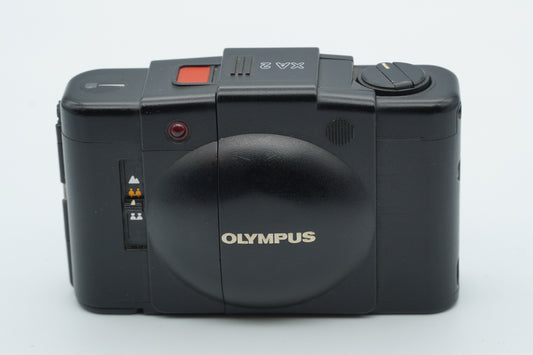 Black Olympus camera on a white background